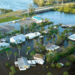 Aerial view of flooded houses next to a river